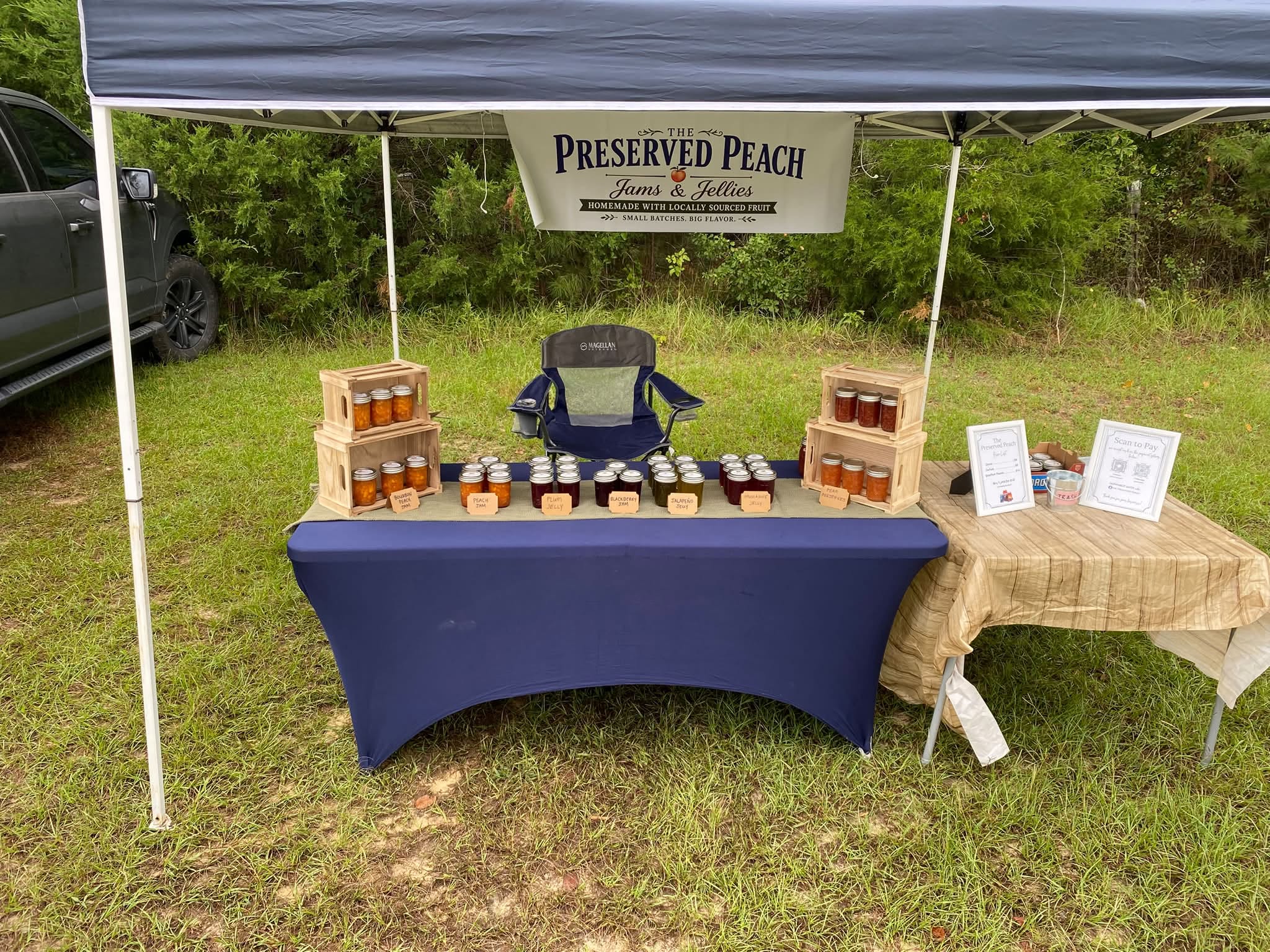 The Preserved Peach market stand with jars of homemade jams and jellies
